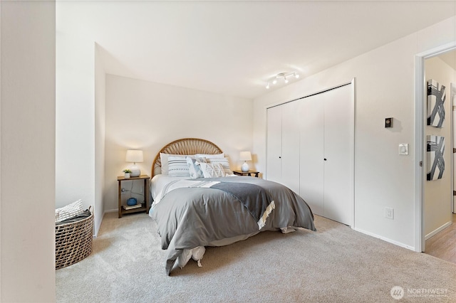 bedroom featuring a closet, carpet, and baseboards