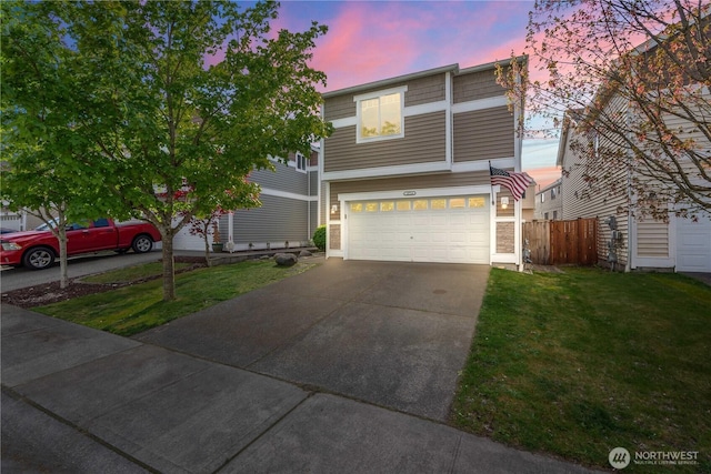 view of front of home with a garage, fence, driveway, and a front yard