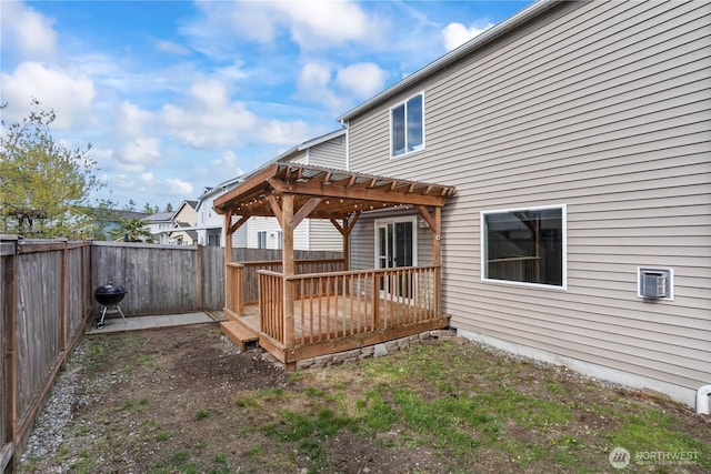 back of house featuring a fenced backyard, a pergola, and a deck