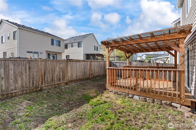 view of yard with a fenced backyard, a residential view, a pergola, and a deck