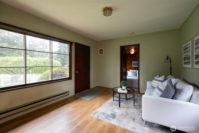living room featuring light wood-style floors and a baseboard radiator