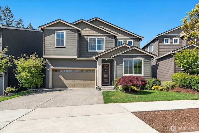 craftsman inspired home with an attached garage and driveway