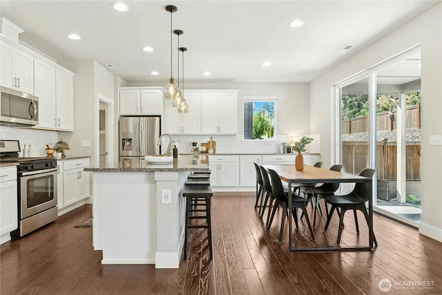 kitchen with recessed lighting, appliances with stainless steel finishes, decorative backsplash, and visible vents