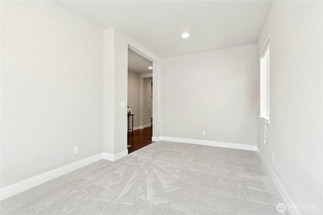 carpeted empty room featuring recessed lighting and baseboards