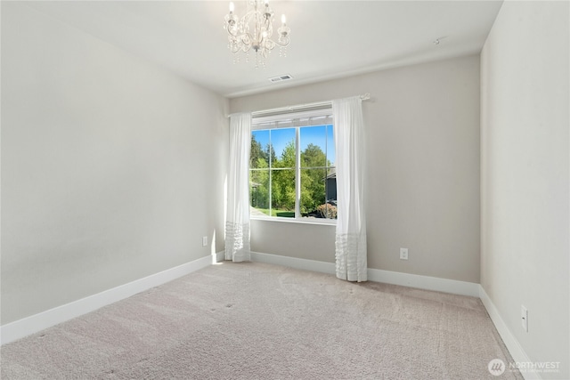 unfurnished room with visible vents, carpet flooring, baseboards, and a chandelier