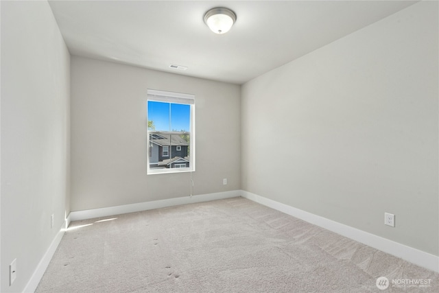 unfurnished room with visible vents, carpet, and baseboards