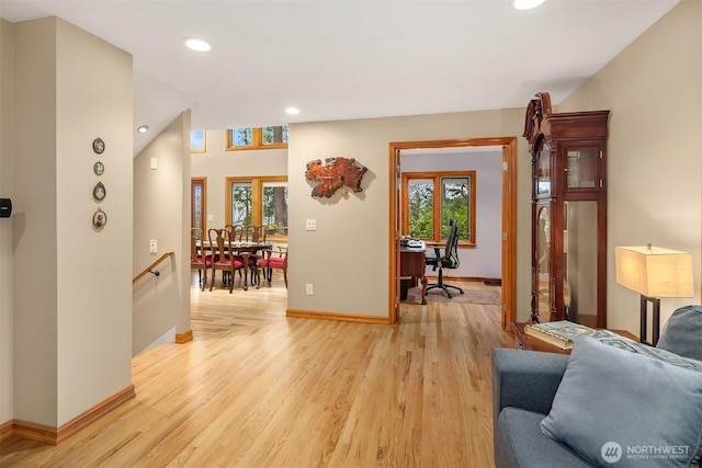 living area with recessed lighting, baseboards, and light wood finished floors