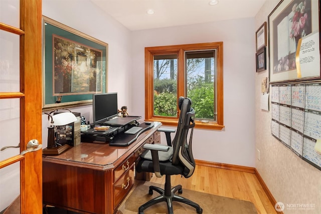 office space featuring baseboards and wood finished floors