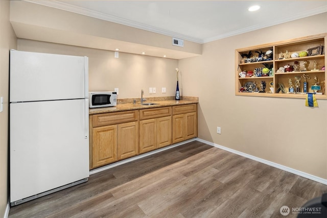 kitchen featuring crown molding, white appliances, wood finished floors, and visible vents