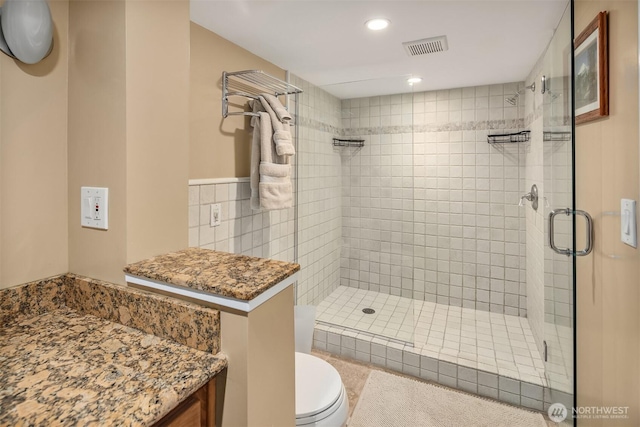bathroom with visible vents, recessed lighting, toilet, and a shower stall