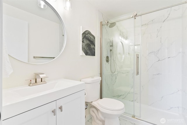 full bathroom featuring vanity, a marble finish shower, and toilet