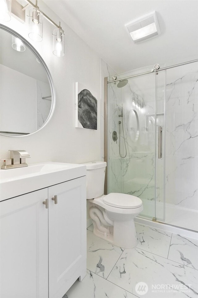 full bathroom featuring visible vents, vanity, marble finish floor, toilet, and a marble finish shower