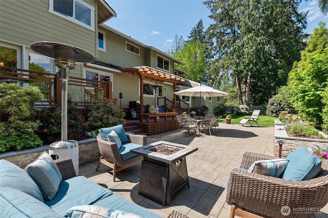 view of patio with a pergola, fence, an outdoor living space with a fire pit, and a deck