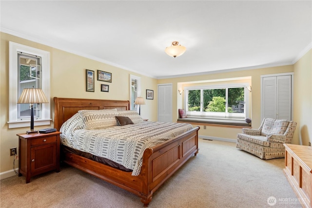 bedroom featuring crown molding, light carpet, and baseboards