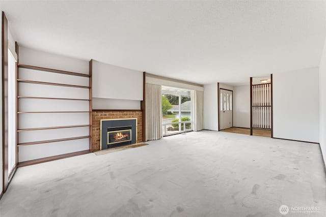 unfurnished living room with light carpet and a fireplace