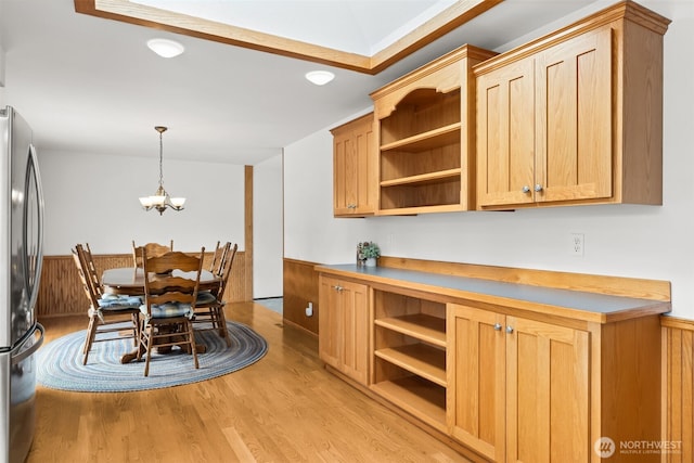 kitchen featuring freestanding refrigerator, open shelves, and light wood-style flooring