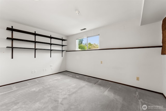 empty room with baseboards and carpet