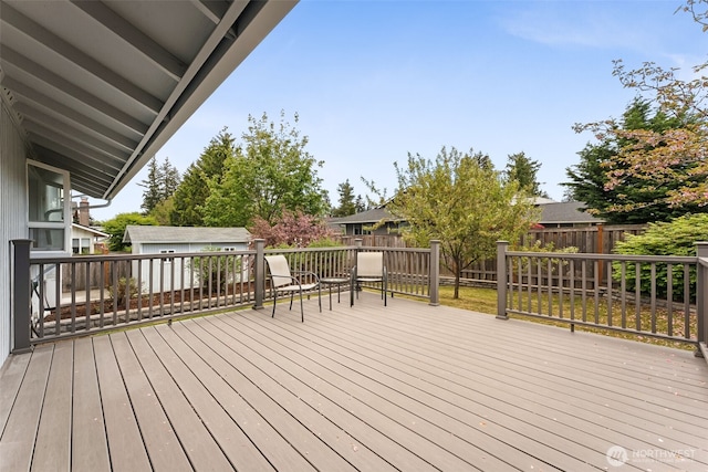 deck with an outbuilding and a fenced backyard