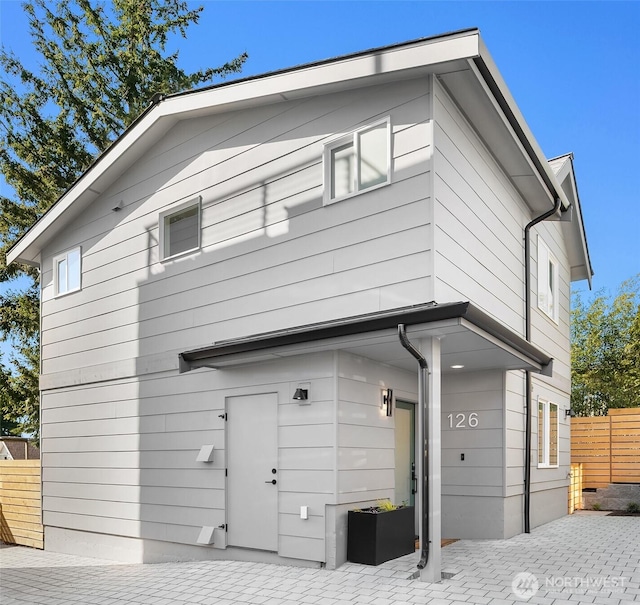 back of house with fence and a patio area