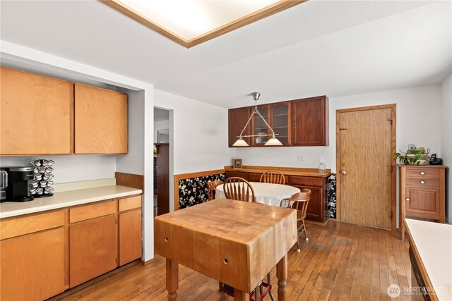 kitchen with light countertops, pendant lighting, and light wood finished floors