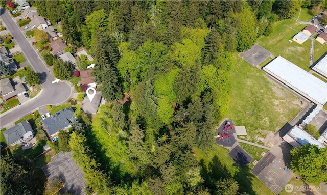 aerial view featuring a wooded view and a residential view