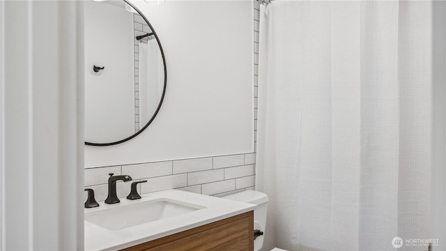 bathroom with vanity, toilet, tile walls, tasteful backsplash, and a shower with curtain