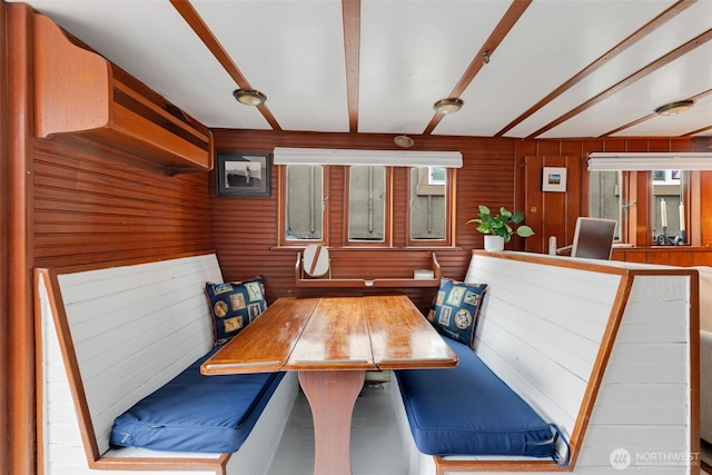 dining room featuring wood walls and breakfast area