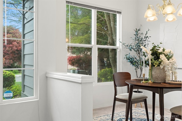 doorway with baseboards and a chandelier