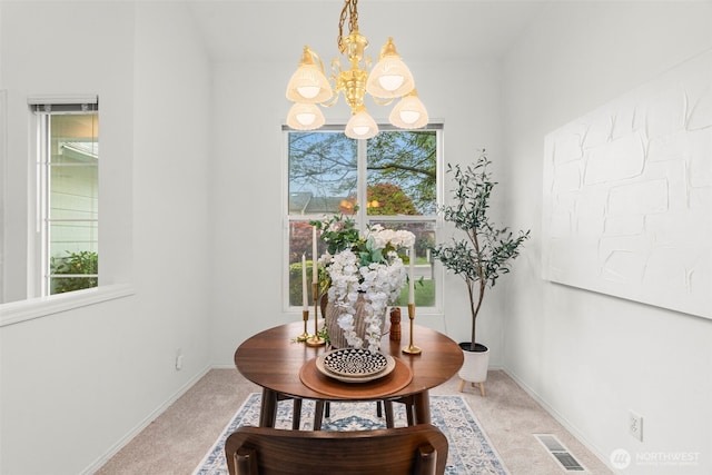dining room with carpet floors, baseboards, a notable chandelier, and visible vents