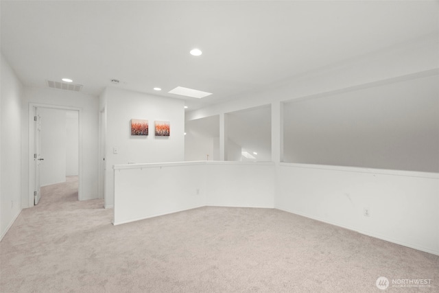 interior space featuring visible vents, recessed lighting, baseboards, and light colored carpet