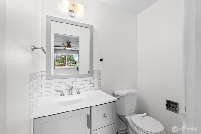 2617 College St SE, Lacey, WA 98503 - half bathroom with vanity, a ceiling fan, backsplash, and toilet