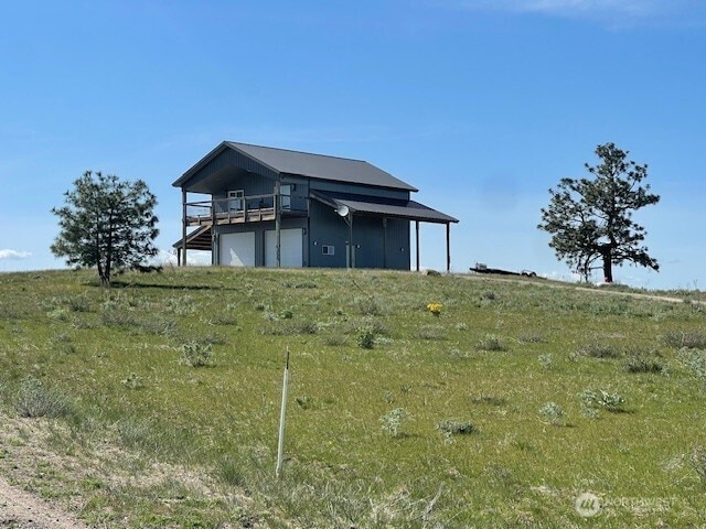 rear view of property with a garage