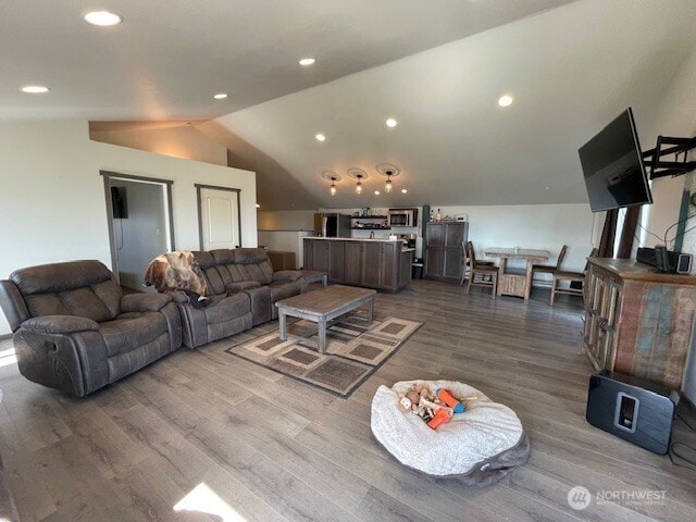 living room featuring recessed lighting, vaulted ceiling, and dark wood-style floors