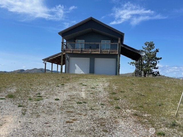 exterior space with a deck, driveway, and a garage