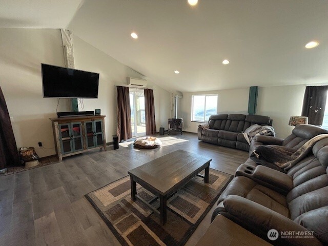living area featuring recessed lighting, a wall mounted AC, and wood finished floors