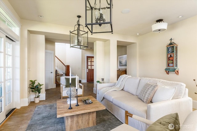 5848 Mutiny Bay Rd, Freeland, WA 98249 - living room featuring baseboards, stairs, wood finished floors, and a notable chandelier