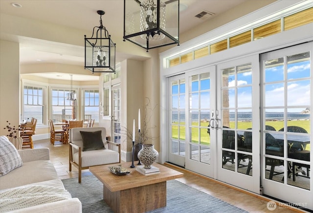 5848 Mutiny Bay Rd, Freeland, WA 98249 - doorway to outside with visible vents, wood finished floors, a chandelier, and french doors