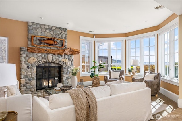 5848 Mutiny Bay Rd, Freeland, WA 98249 - living area with visible vents, baseboards, wood finished floors, and a fireplace