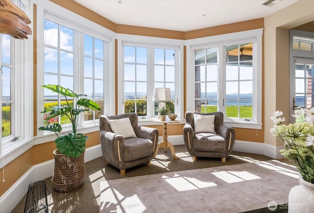 5848 Mutiny Bay Rd, Freeland, WA 98249 - sunroom / solarium featuring baseboards, carpet flooring, and a water view