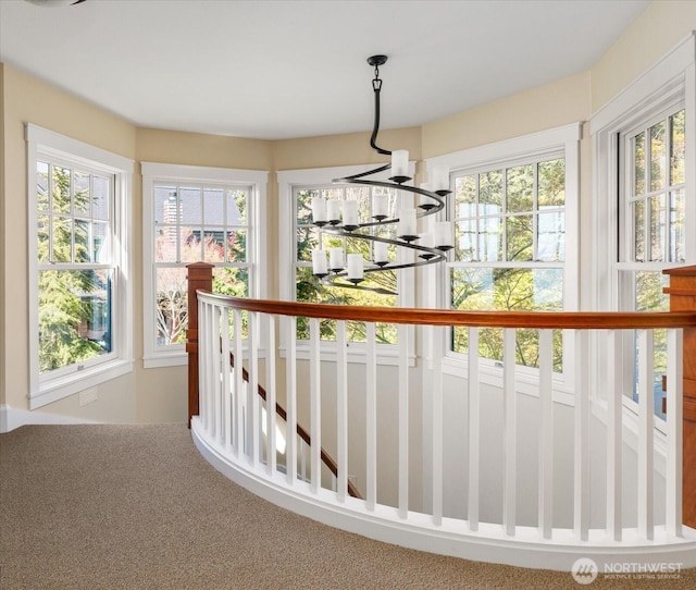 5848 Mutiny Bay Rd, Freeland, WA 98249 - stairway featuring carpet flooring, a notable chandelier, and a wealth of natural light