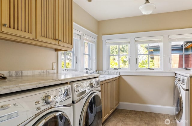 5848 Mutiny Bay Rd, Freeland, WA 98249 - laundry room with a sink, baseboards, cabinet space, and independent washer and dryer