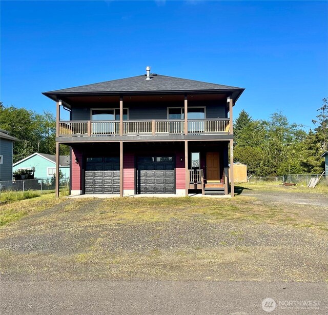 415 Olympic View Dr NE, Ocean Shores, WA 98569 - view of front of property featuring driveway, an attached garage, and a balcony