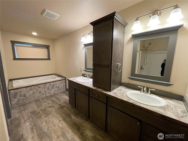 415 Olympic View Dr NE, Ocean Shores, WA 98569 - full bathroom featuring wood finished floors, a garden tub, and double vanity