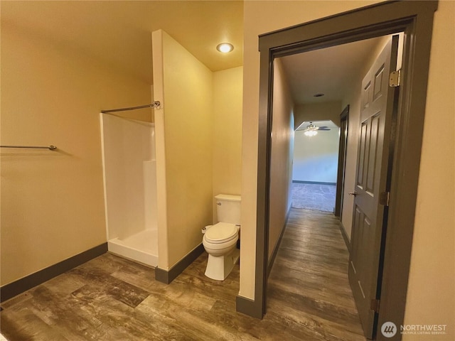 415 Olympic View Dr NE, Ocean Shores, WA 98569 - bathroom featuring toilet, a stall shower, wood finished floors, and baseboards