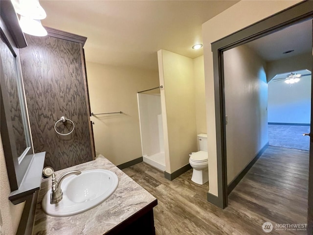 415 Olympic View Dr NE, Ocean Shores, WA 98569 - full bath featuring toilet, wood finished floors, vanity, ceiling fan, and a shower