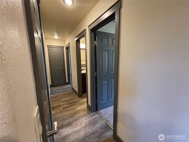 415 Olympic View Dr NE, Ocean Shores, WA 98569 - hall featuring dark wood finished floors, a textured wall, and baseboards