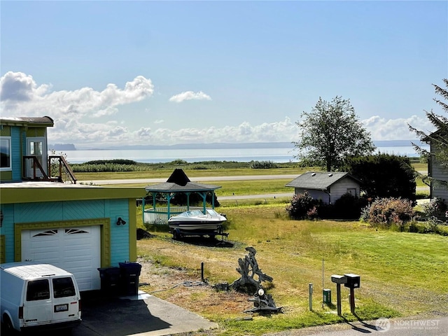 415 Olympic View Dr NE, Ocean Shores, WA 98569 - view of green lawn with a garage