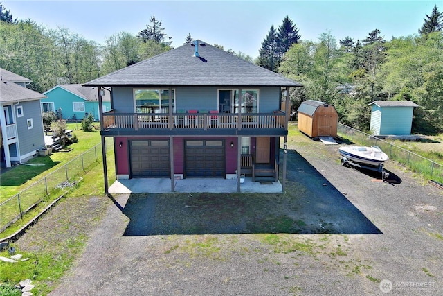 415 Olympic View Dr NE, Ocean Shores, WA 98569 - back of house with asphalt driveway, roof with shingles, and a garage