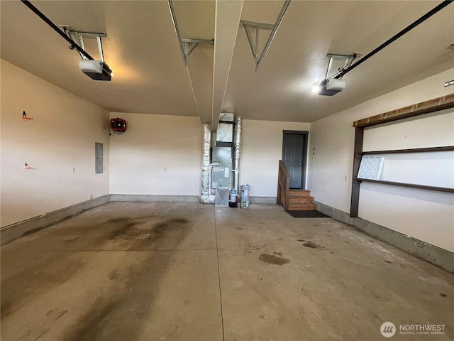 415 Olympic View Dr NE, Ocean Shores, WA 98569 - garage featuring a garage door opener, electric panel, heating unit, and baseboards