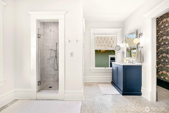 full bathroom featuring baseboards, tile patterned flooring, vanity, and a shower stall